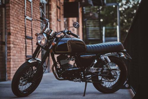 brand-new-shiny-black-retro-chopper-is-parked-brick-building